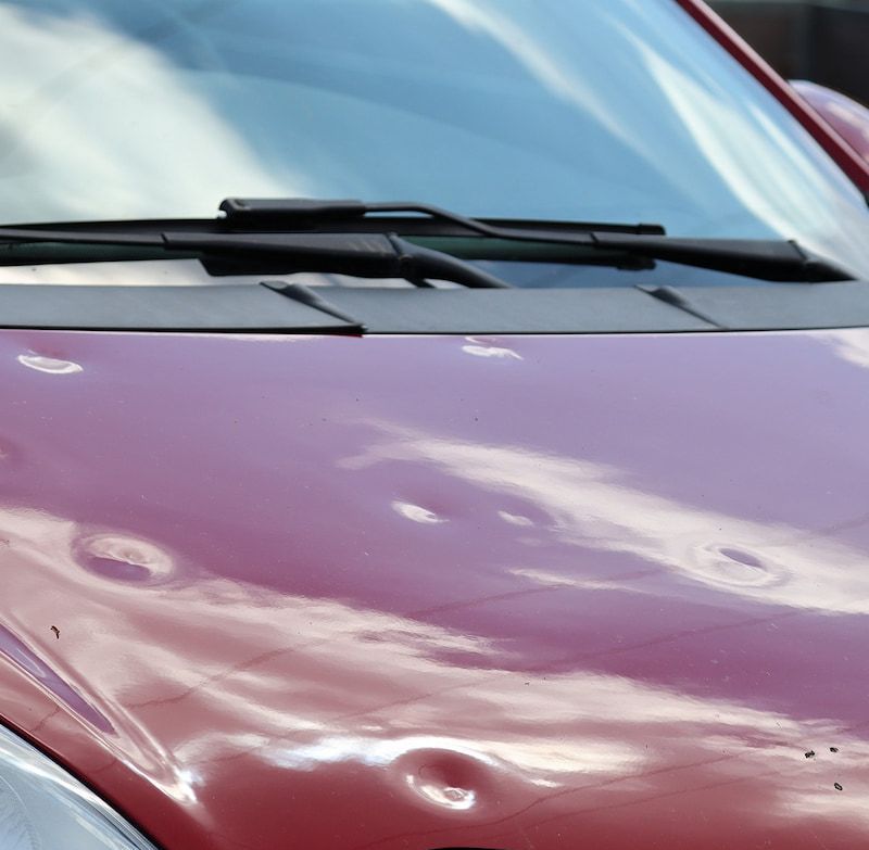 A Red Car With Dents on the Hood — Dynamic Dentz Smash Repair in South Nowra, NSW