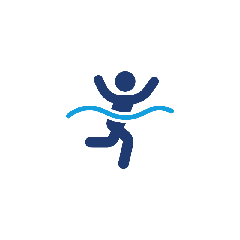 Person running through water with arms raised, celebrating.