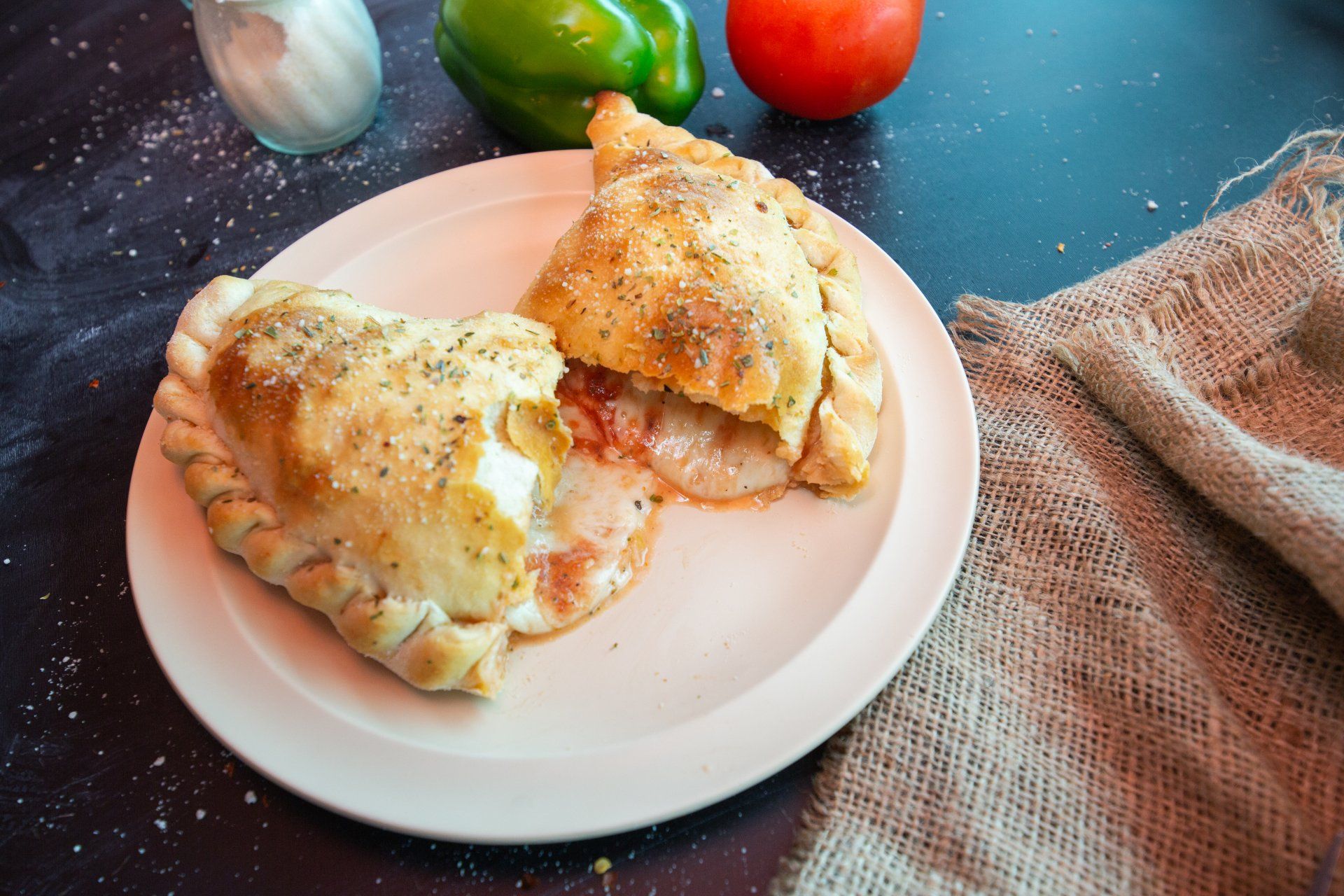 A white plate topped with a slice of pizza.