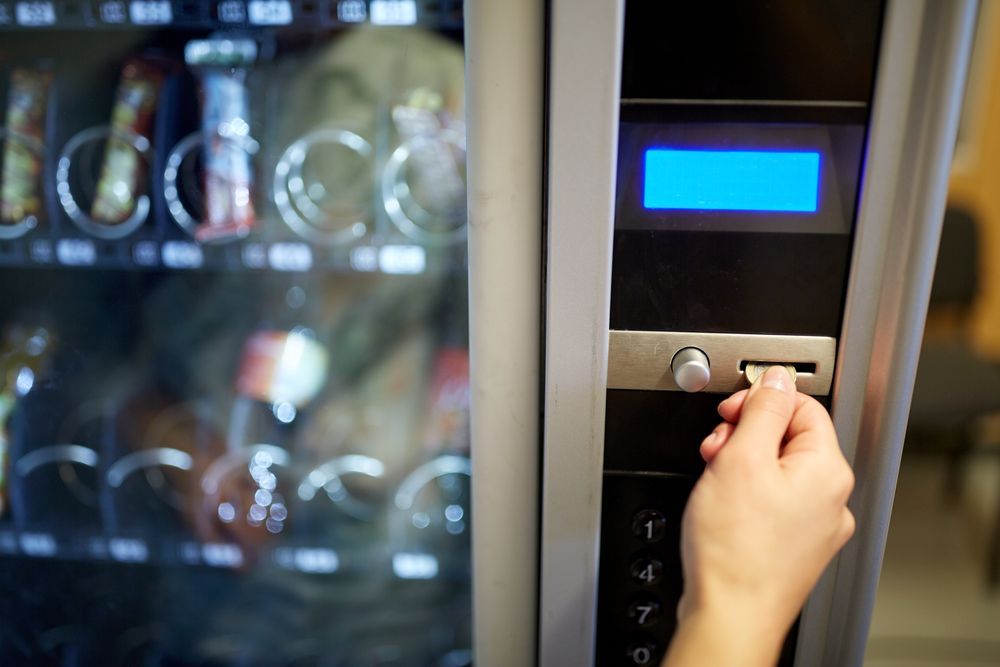 Hand Inserting a Coin Into a Vending Machine — SealTite in Lismore, NSW