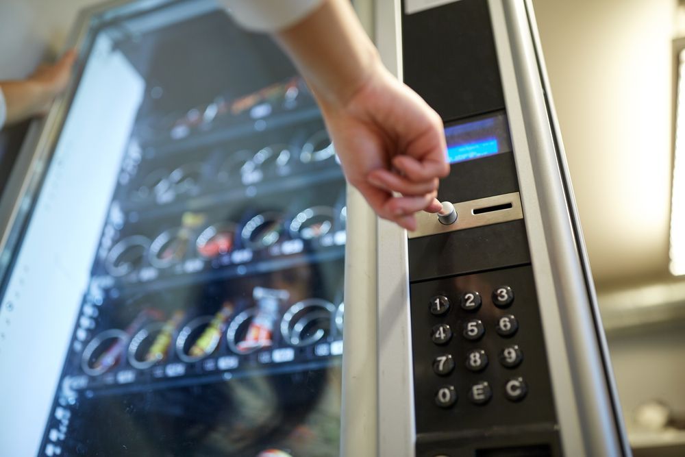 Hand Inserting a Key Into a Vending Machine to Unlock It — SealTite in Terranora, NSW