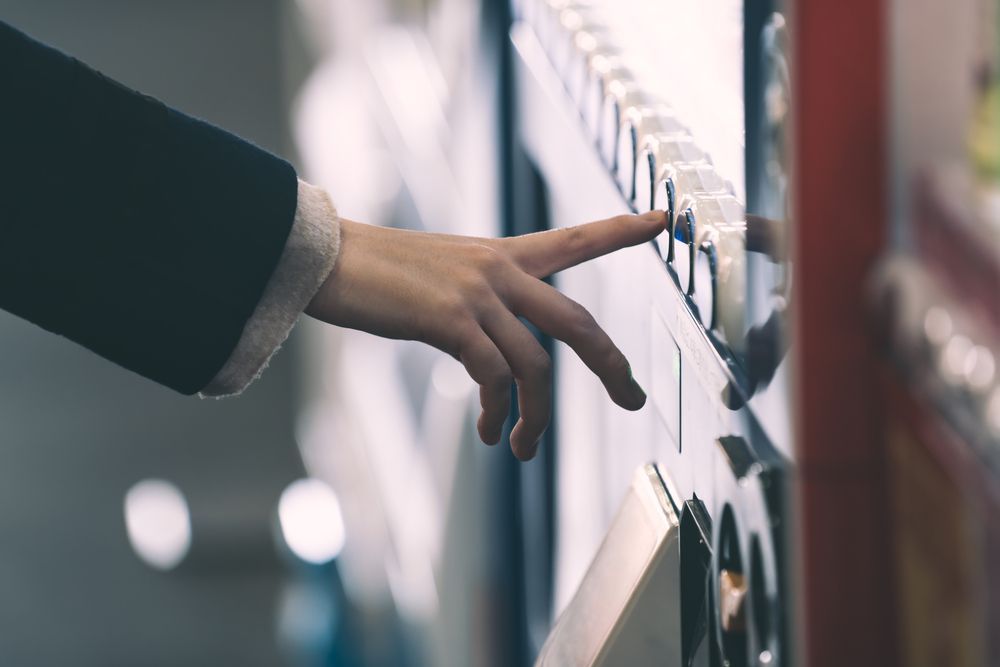 A Person's Hand Pressing a Button on a Vending Machine — SealTite in Ballina, NSW