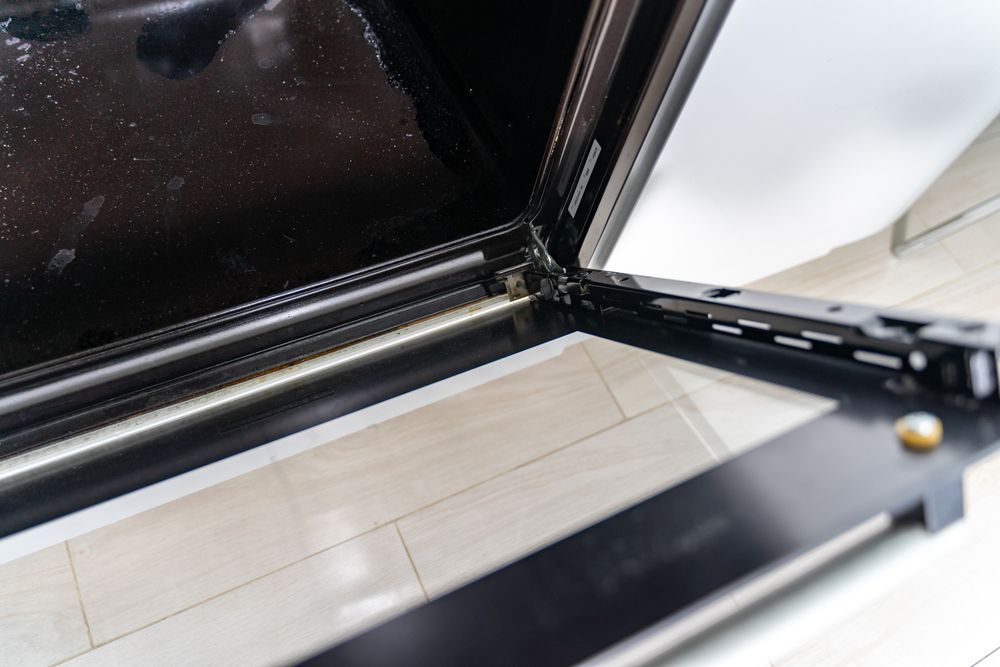 Close-up of a Black Oven Door Frame With a Glass Panel — SealTite in Ballina, NSW