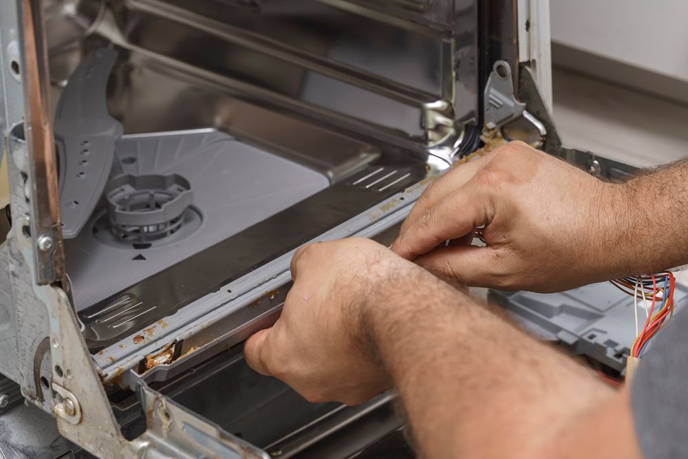 Hands Repair a Dishwasher, Manipulating Internal Components — SealTite in Lismore, NSW
