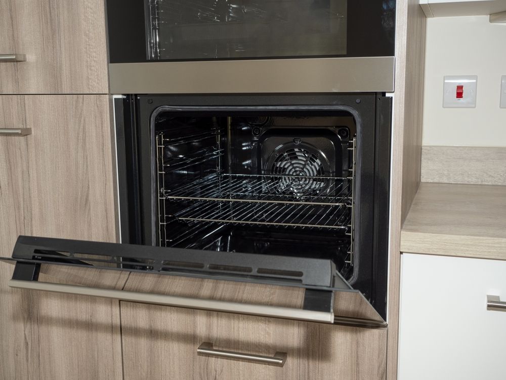 Open Oven in a Light Wood Kitchen Cabinet; Stainless Steel Trim — SealTite in Gold Coast, QLD