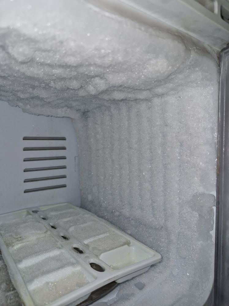 Interior of a Freezer Heavily Coated in Frost With an Ice Tray in the Foreground — SealTite in Tweed Heads, NSW