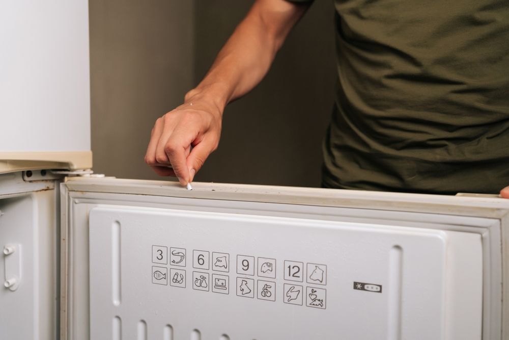 Person Points at the Seal of a White Refrigerator Freezer Door — SealTite in Kingscliff, NSW