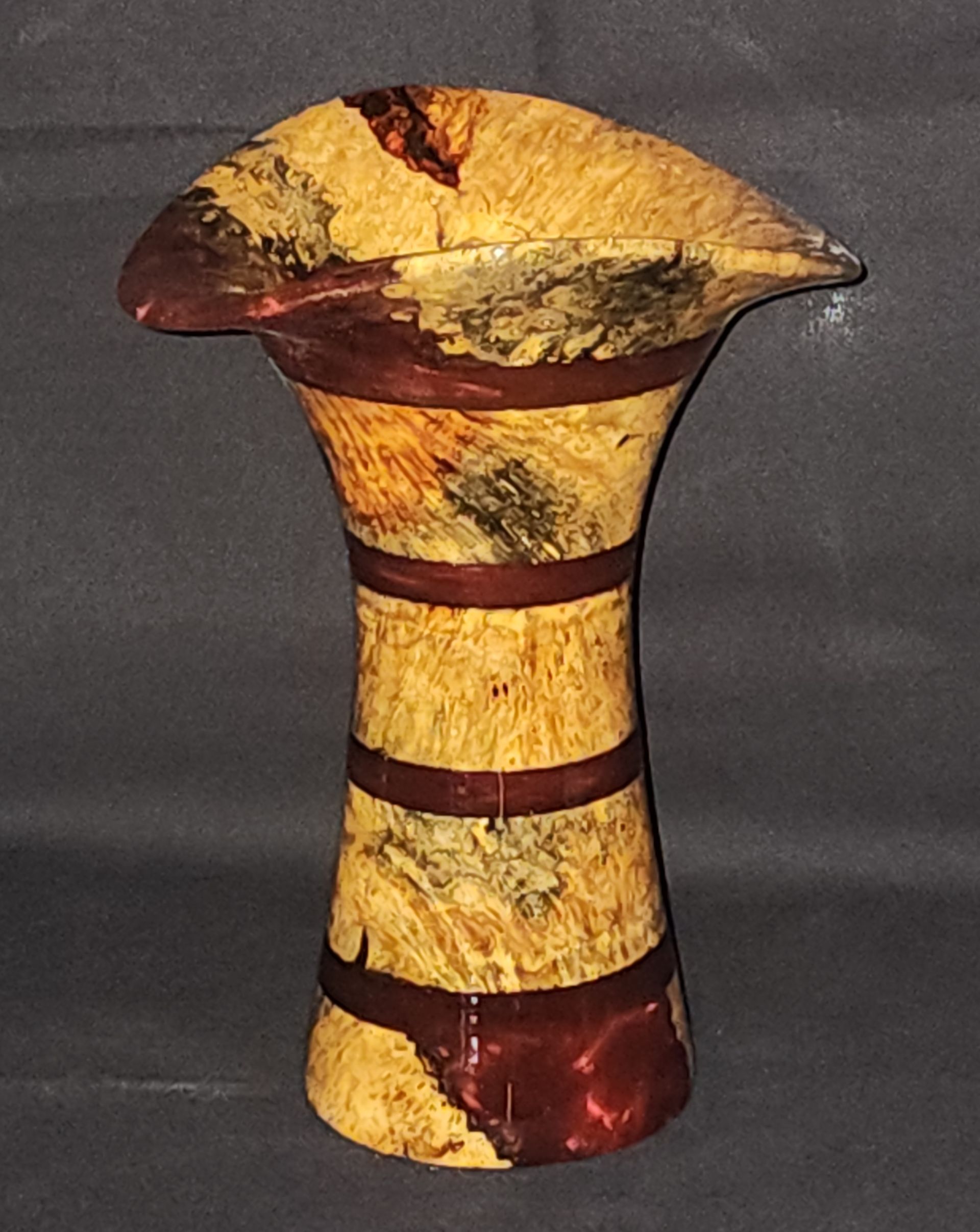 White and brown organic-shaped wooden vase with an open center.