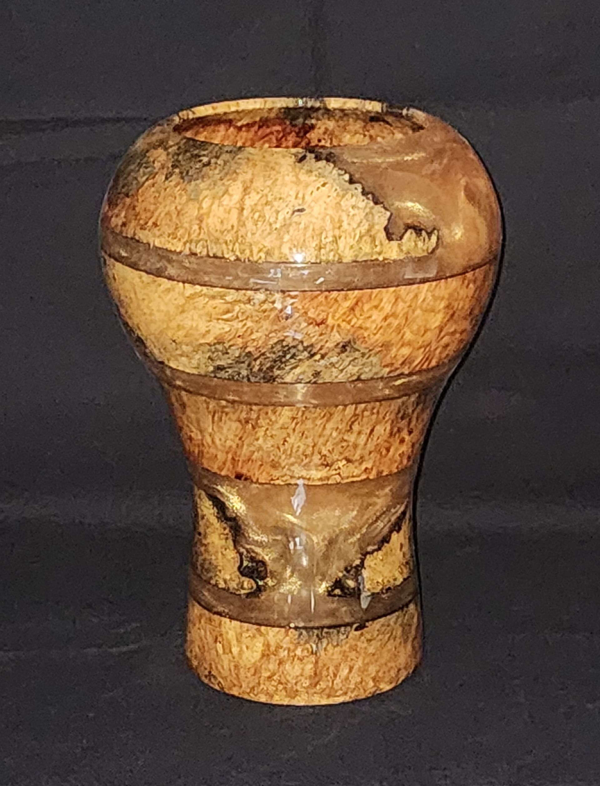 Wooden vase with blue resin interior and black dolphin silhouettes.