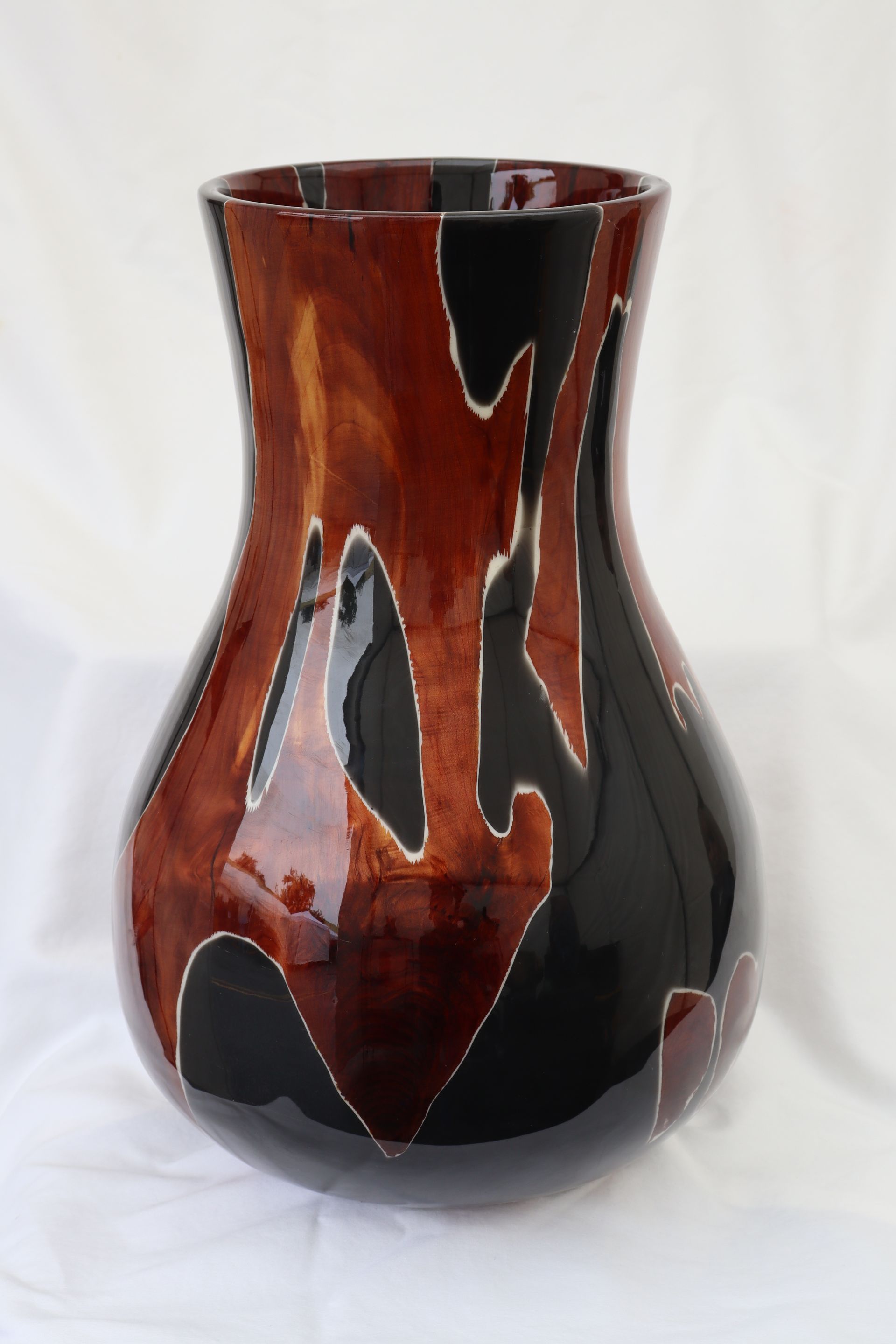 Wooden vase with blue resin interior and black dolphin silhouettes.