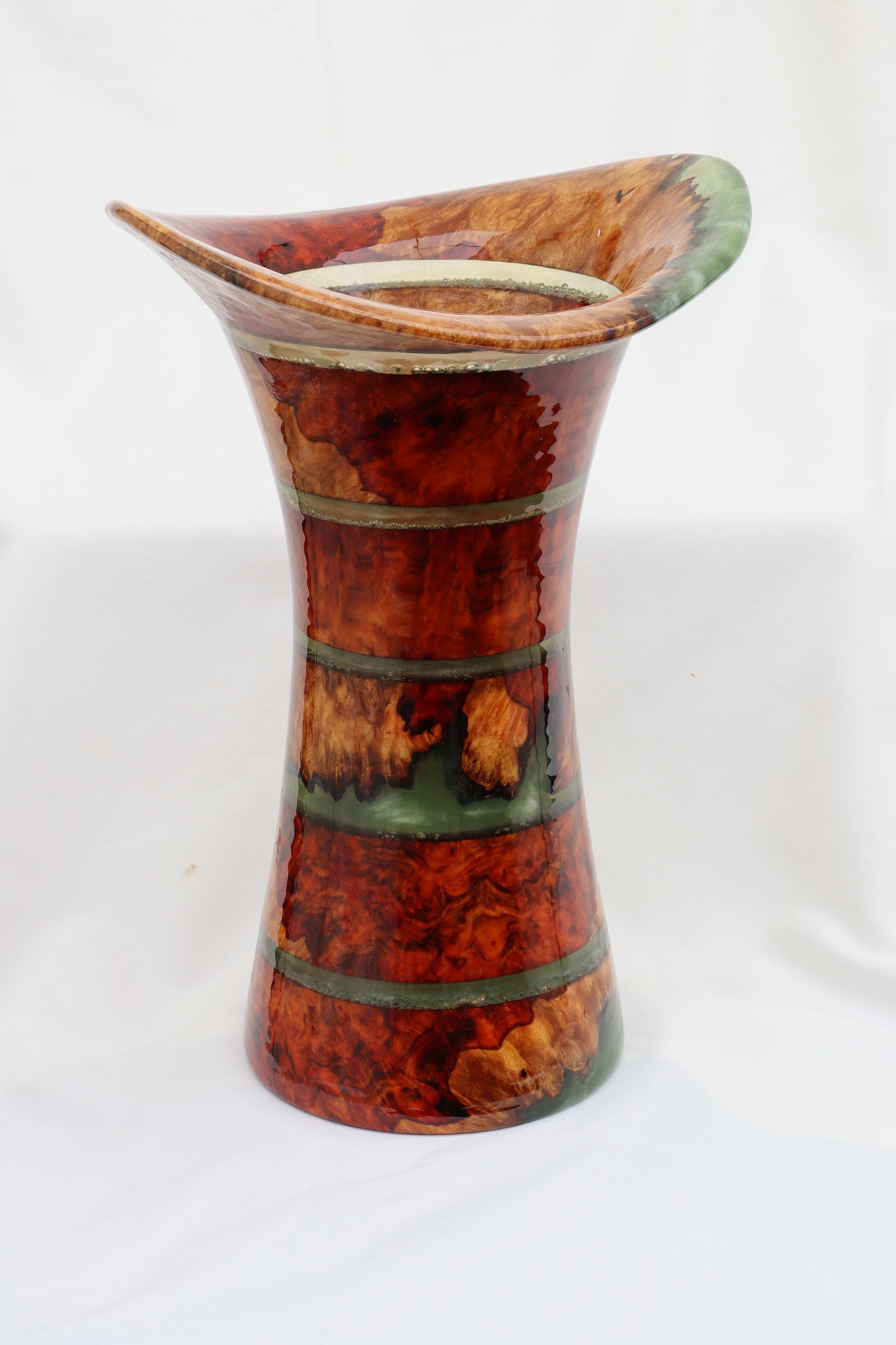 White and brown organic-shaped wooden vase with an open center.