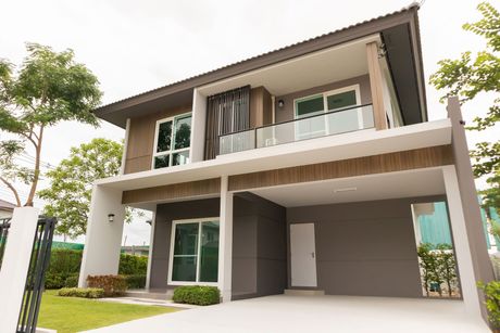 A large house with a lot of windows and a garage.