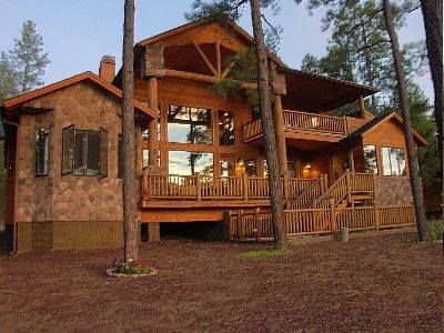A large log cabin in the middle of a forest