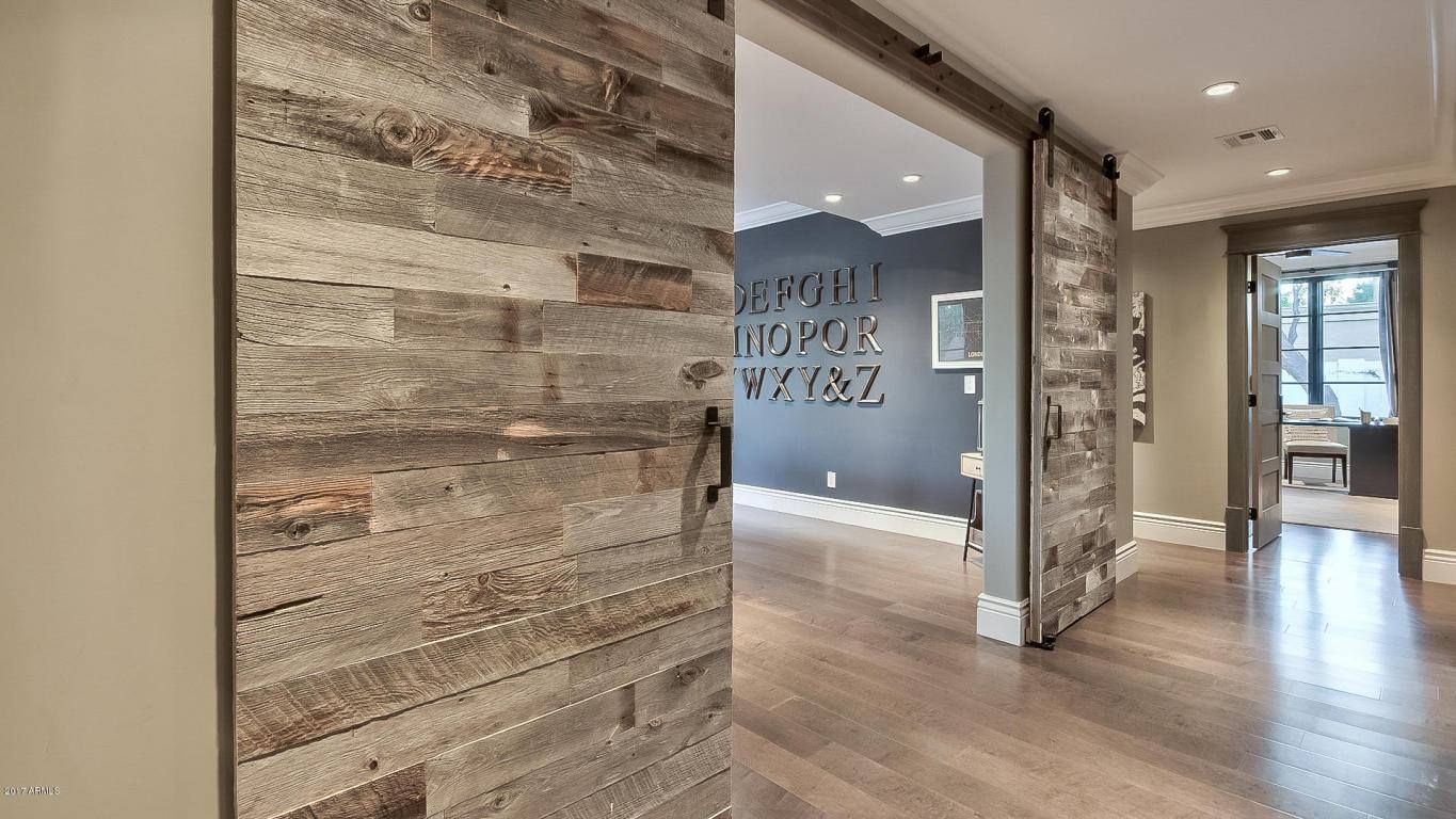 A hallway with a wooden wall and a wooden floor