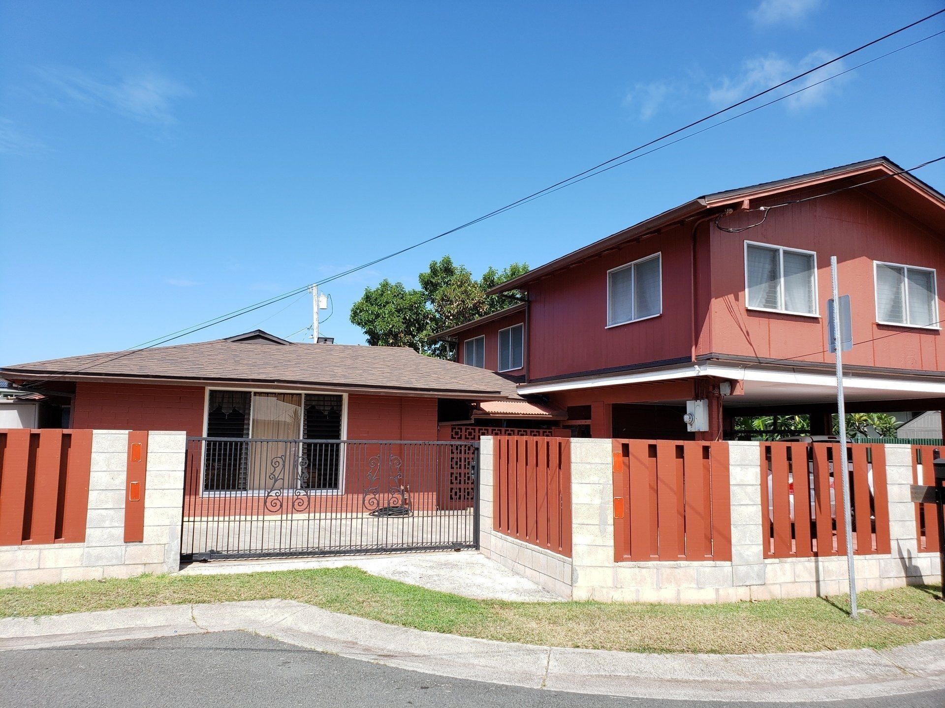 A large red house with a fence in front of it.
