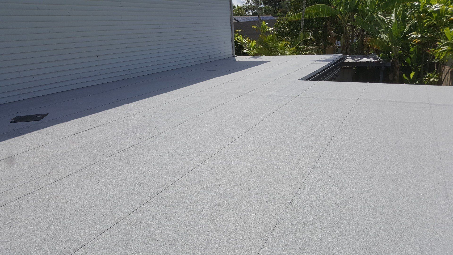 A roof with a drain hole in the middle of it.