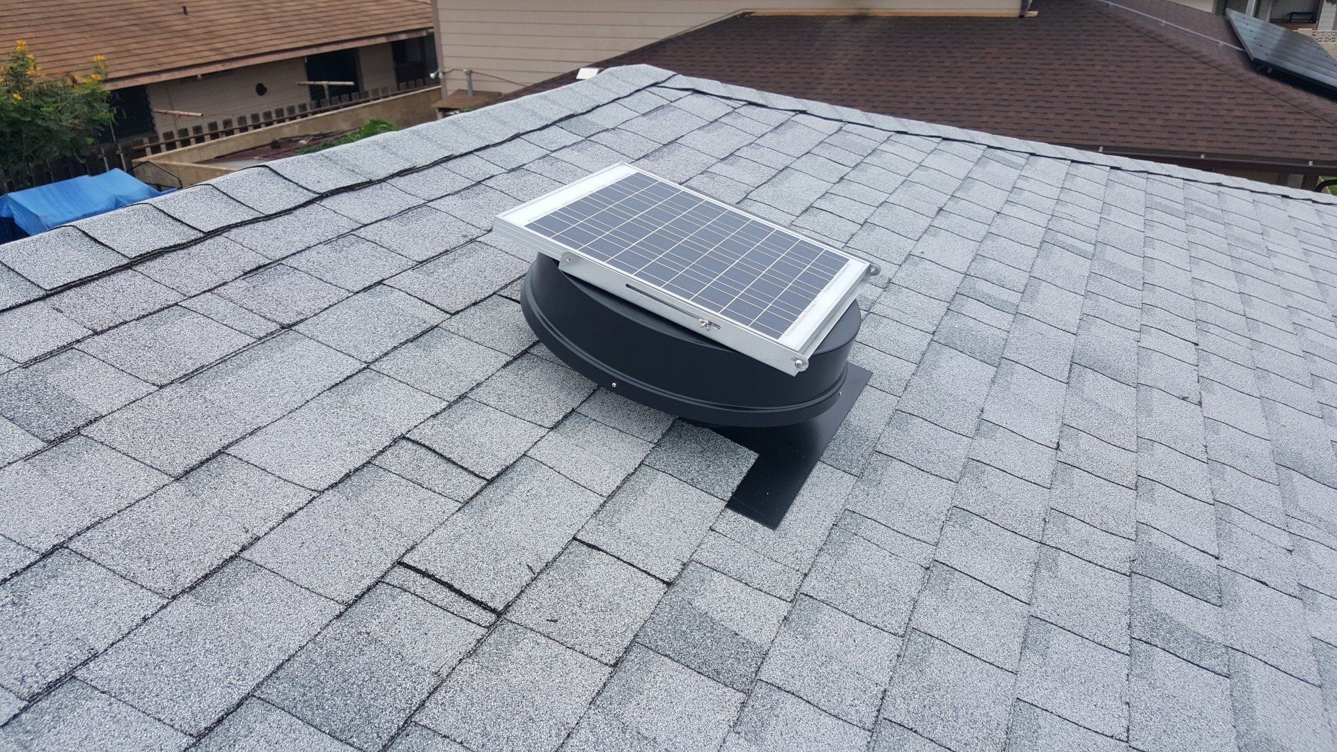 A solar panel is sitting on top of a roof.