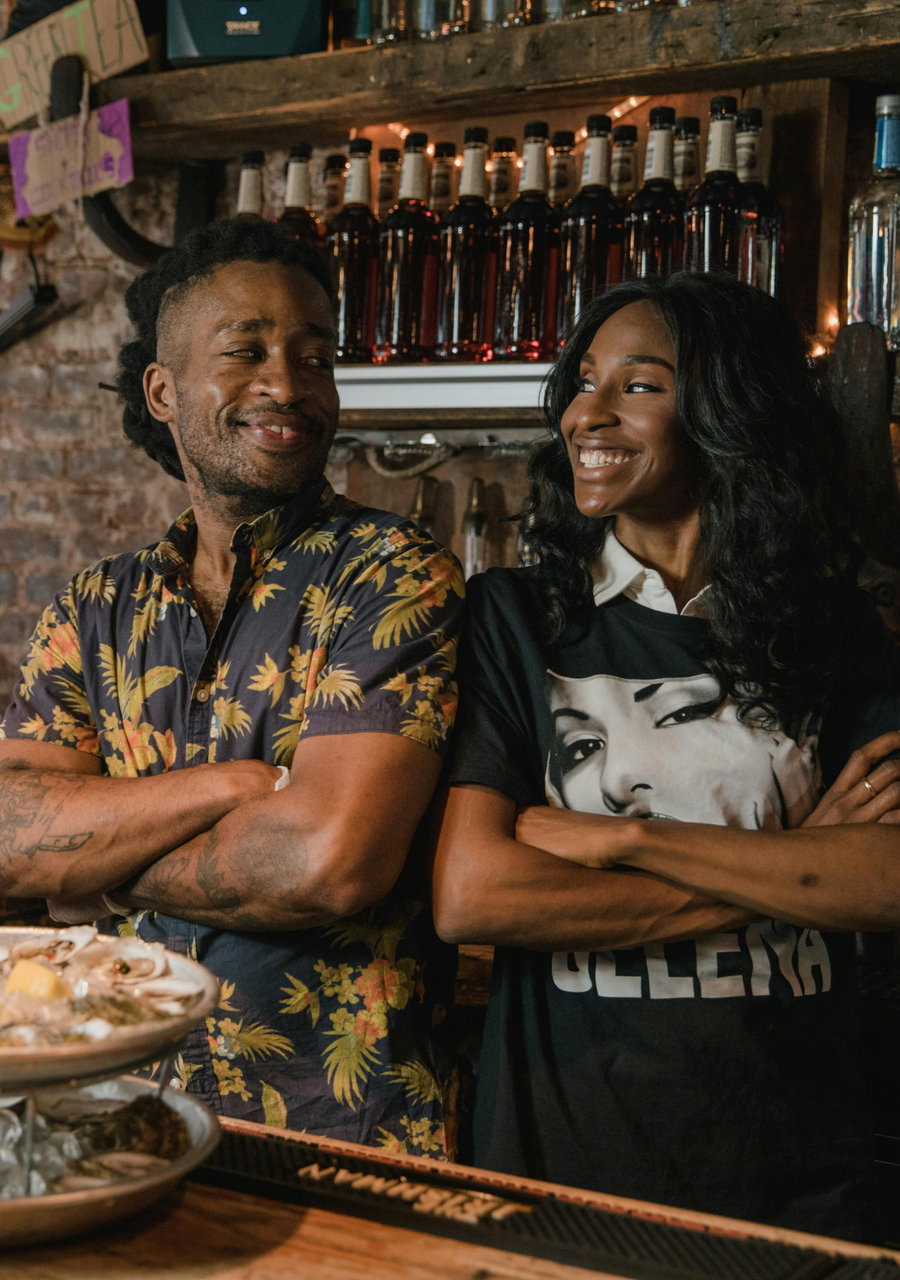 A woman and a man are smiling at each other in a restaurant