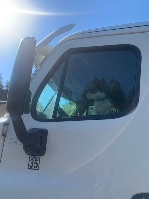 A manhole cover with a hose coming out of it.