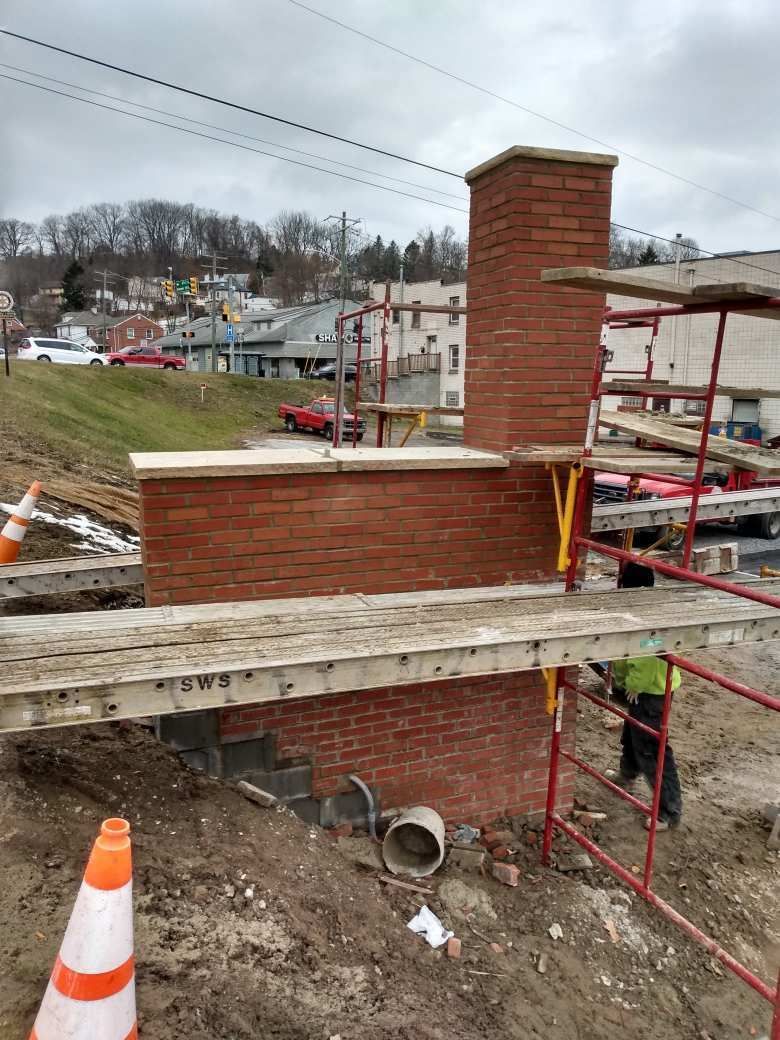 Bricklayer industrial worker installing brick masonry – Rochester, PA - Luick & Sons Contracting Inc