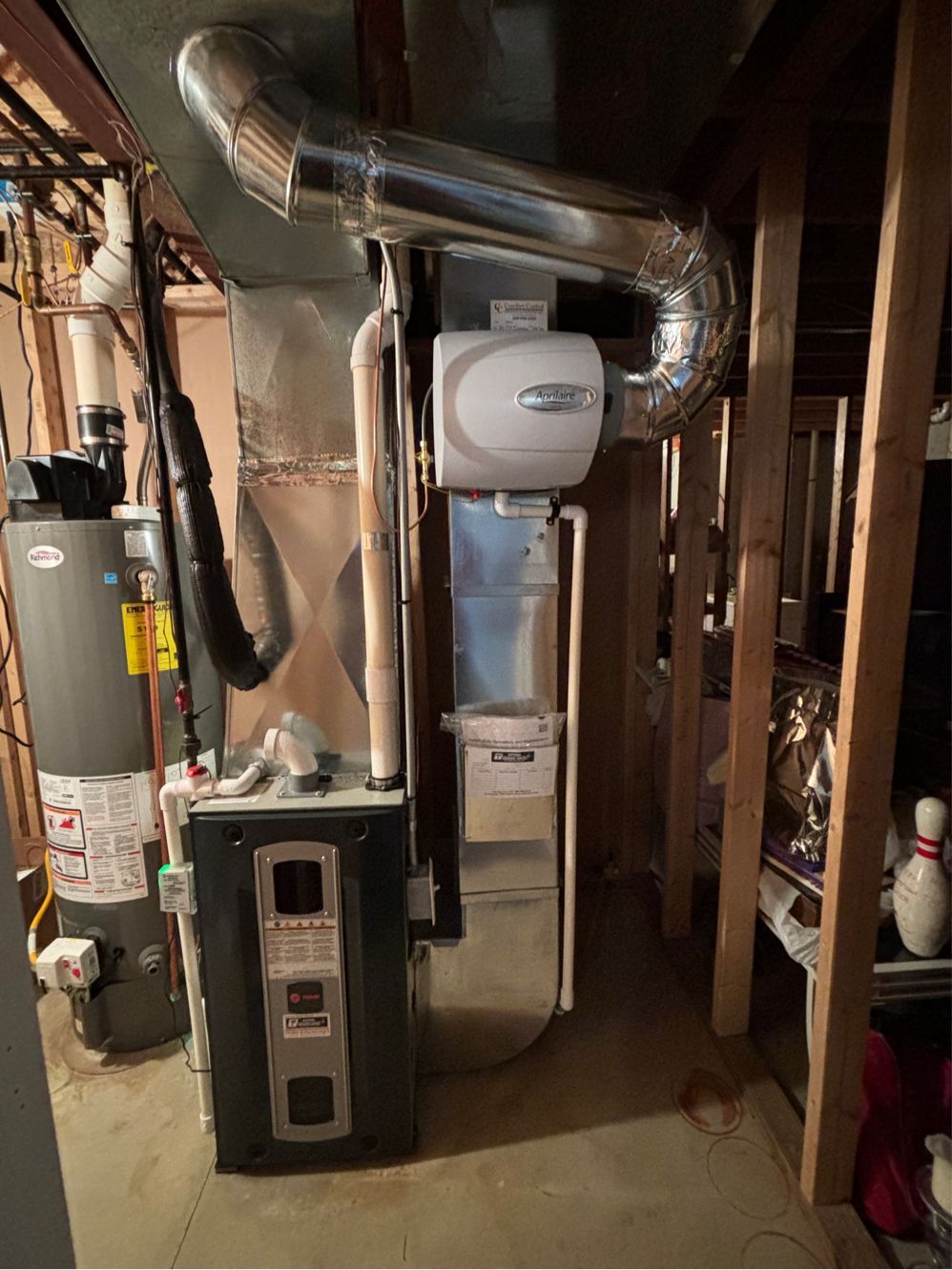 An air conditioner and a water heater in a basement