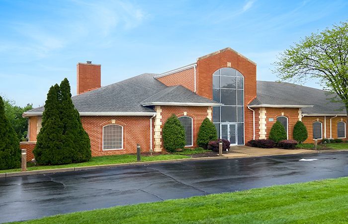 a large brick building with a parking lot in front of it