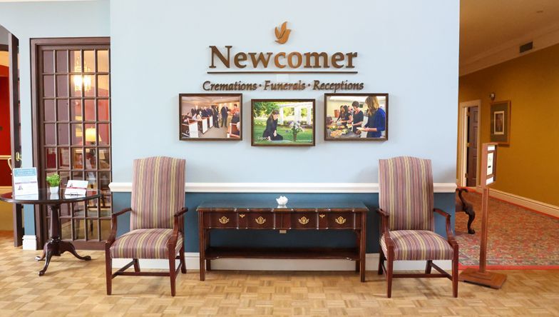 A room with chairs and a sign that says newcomer