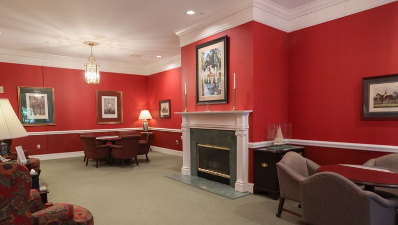 A living room with red walls and a fireplace