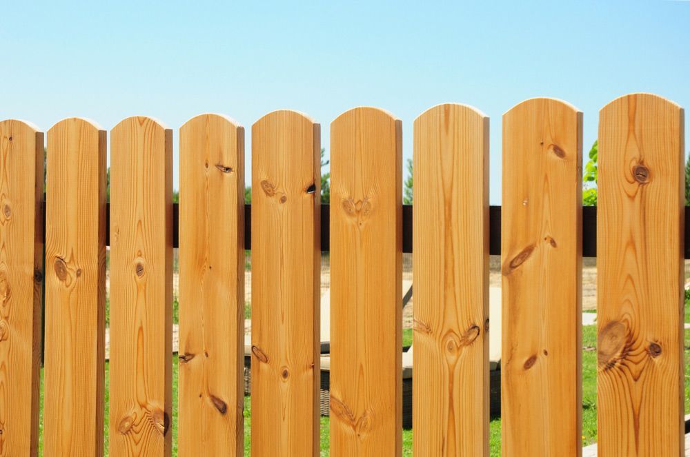 A Close up Of a Wooden Fence with A Blue Sky in The Background — Gnomes Landscape & Garden Supplies In Laurieton, NSW