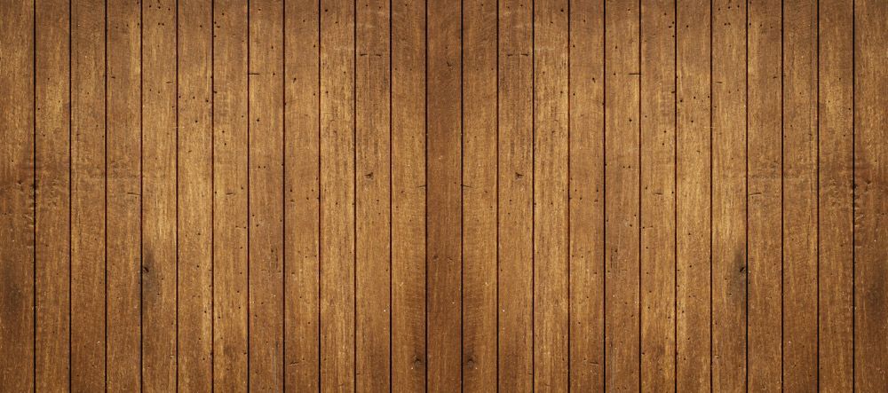 A Close up Of a Wooden Floor with A Wooden Fence in The Background — Gnomes Landscape & Garden Supplies In Harrington, NSW