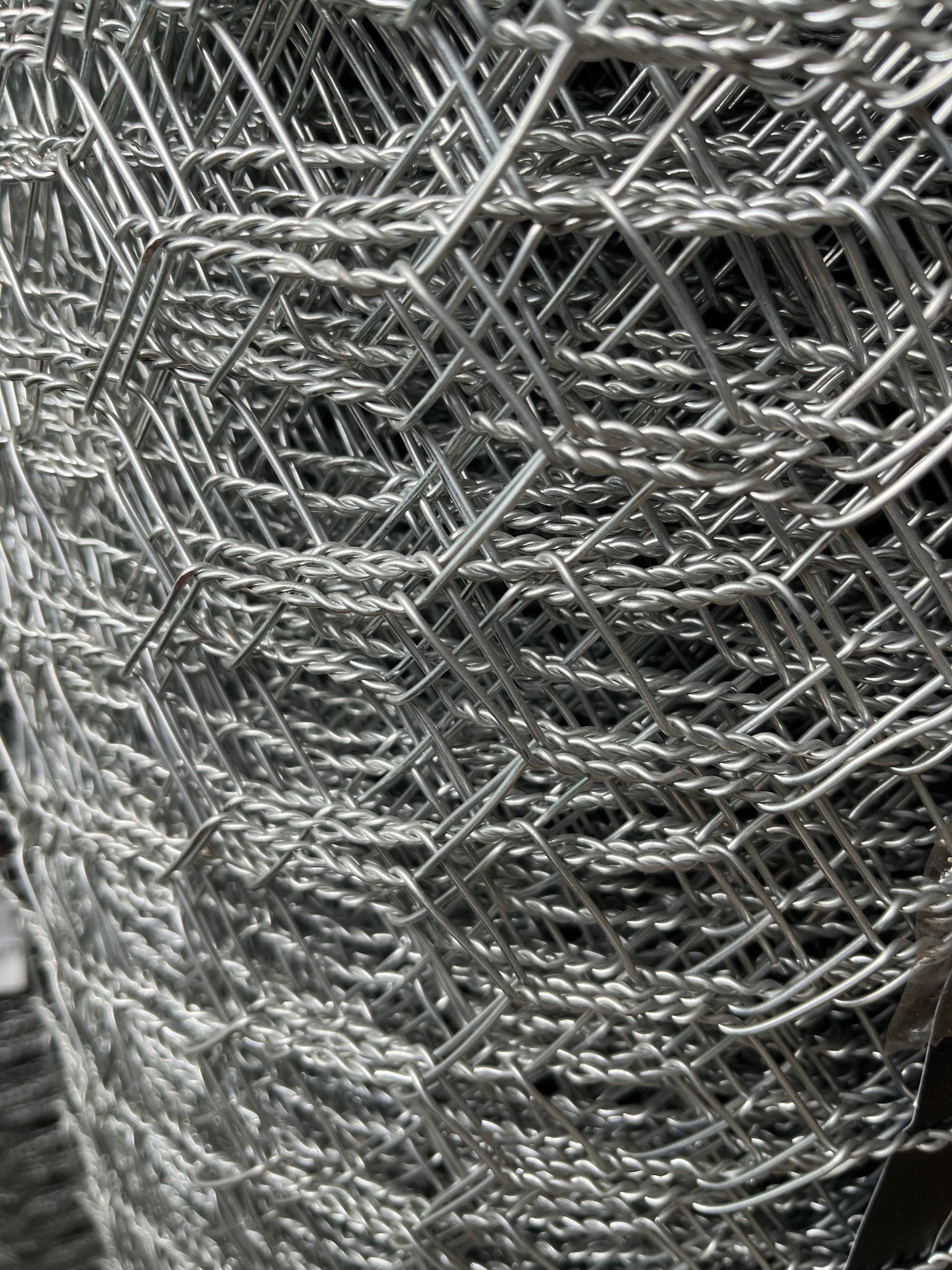 A Barbed Wire Fence Surrounds a Grassy Field — Gnomes Landscape & Garden Supplies In Taree South, NSW