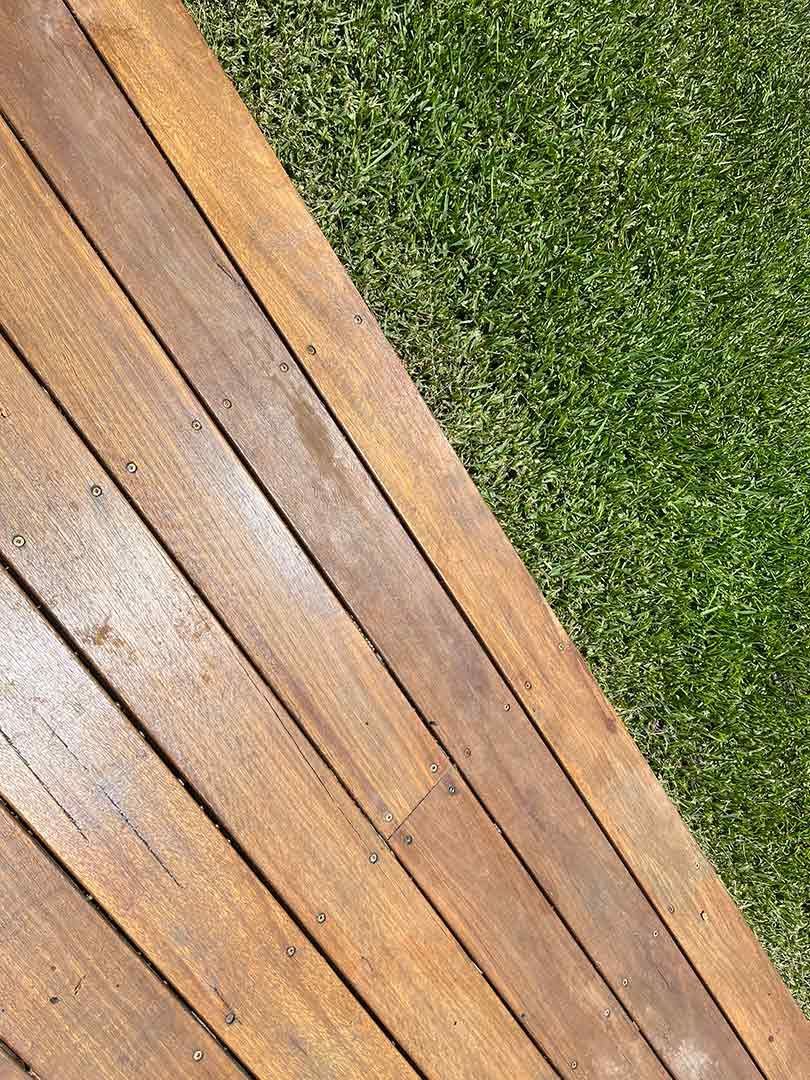 A Wooden Deck Next To A Lush Green Lawn — Gnomes Landscape & Garden Supplies In Taree South, NSW