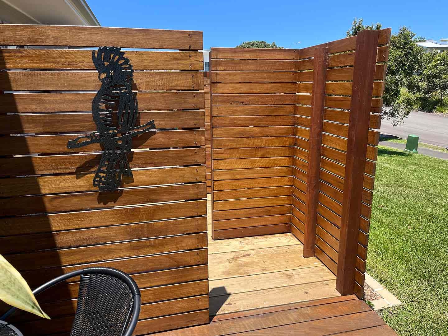 A Wooden Fence With A Shadow Of A Bird On It — Gnomes Landscape & Garden Supplies In Harrington, NSW