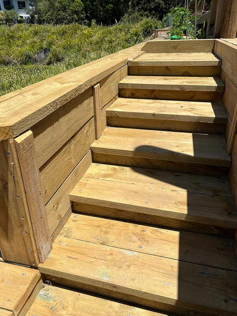 A Set Of Wooden Stairs Leading Up To A Wooden Deck — Gnomes Landscape & Garden Supplies In Pacific Palms, NSW