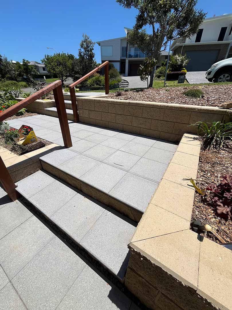 A Set Of Stairs Leading Up To A House With A Wooden Railing — Gnomes Landscape & Garden Supplies In Forster, NSW