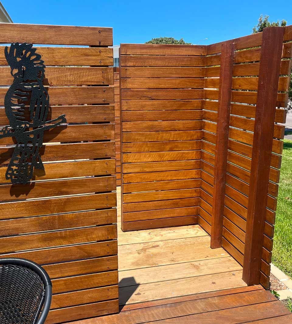 A Wooden Fence With A Shadow Of A Seahorse On It — Gnomes Landscape & Garden Supplies In Laurieton, NSW