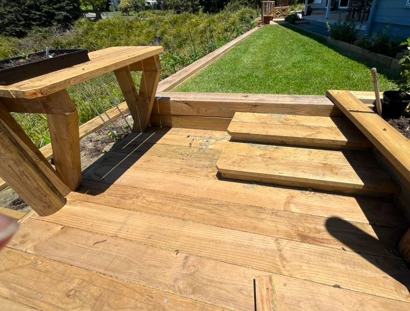 A Wooden Deck With Stairs Leading Up To A Grassy Yard — Gnomes Landscape & Garden Supplies In Harrington, NSW