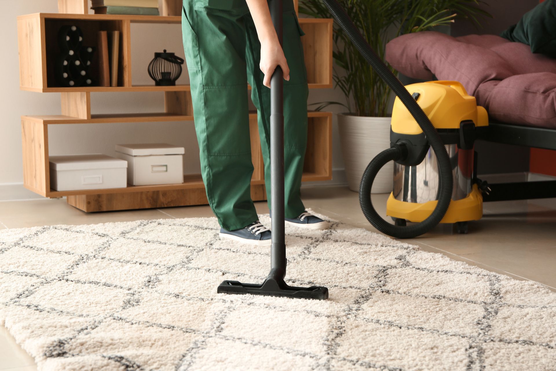 Unrecognized worker providing area rug cleaning services.