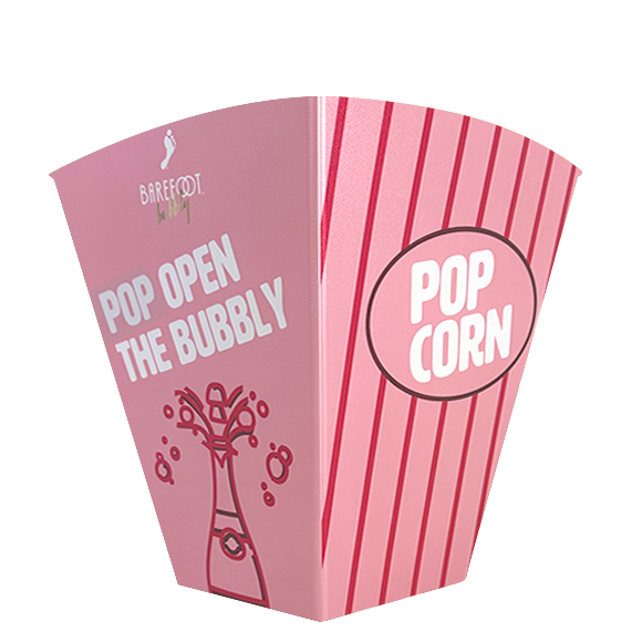 Pink and white popcorn box with "Pop Open the Bubbly" and "Popcorn" text.