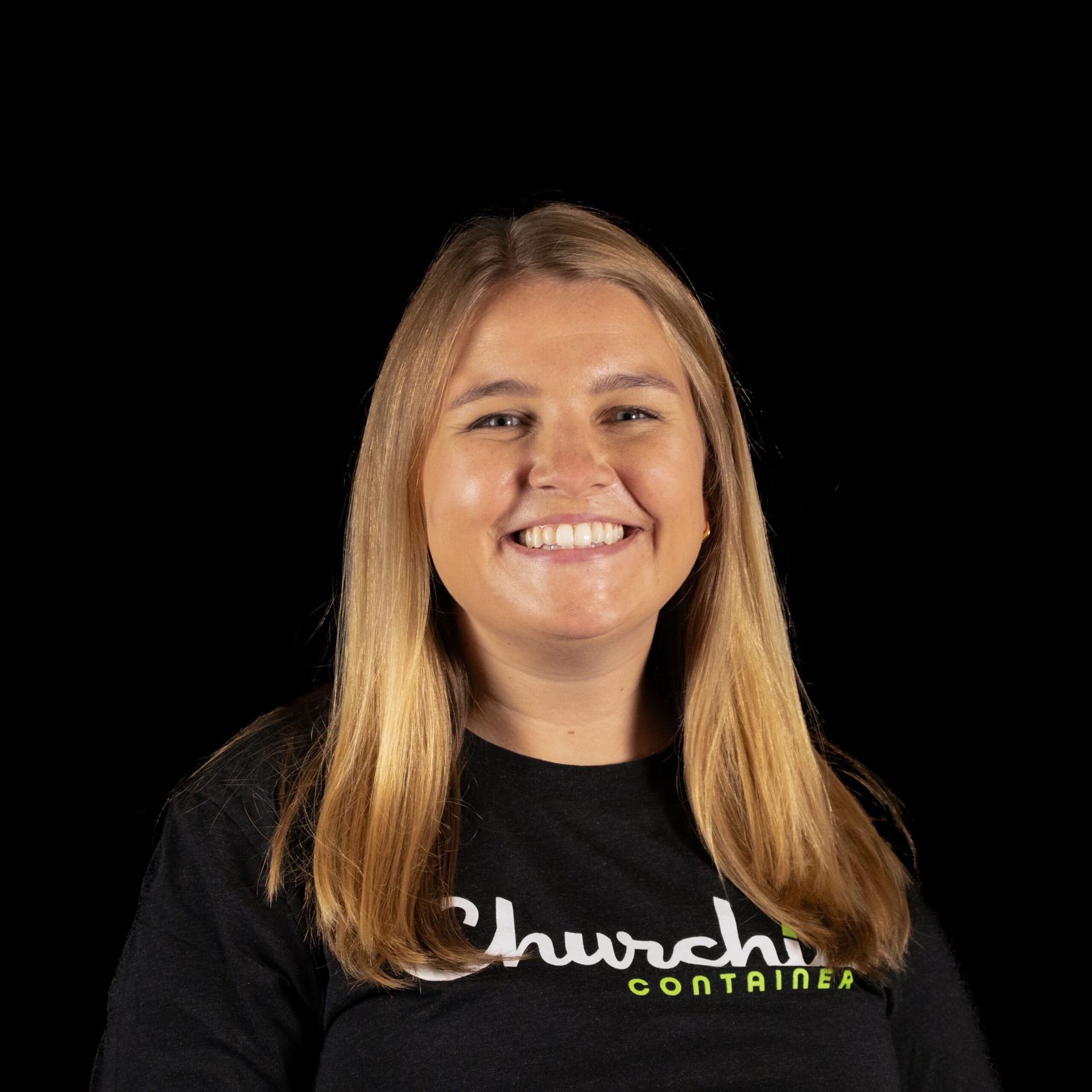 Woman with blonde hair wearing a black shirt that says 