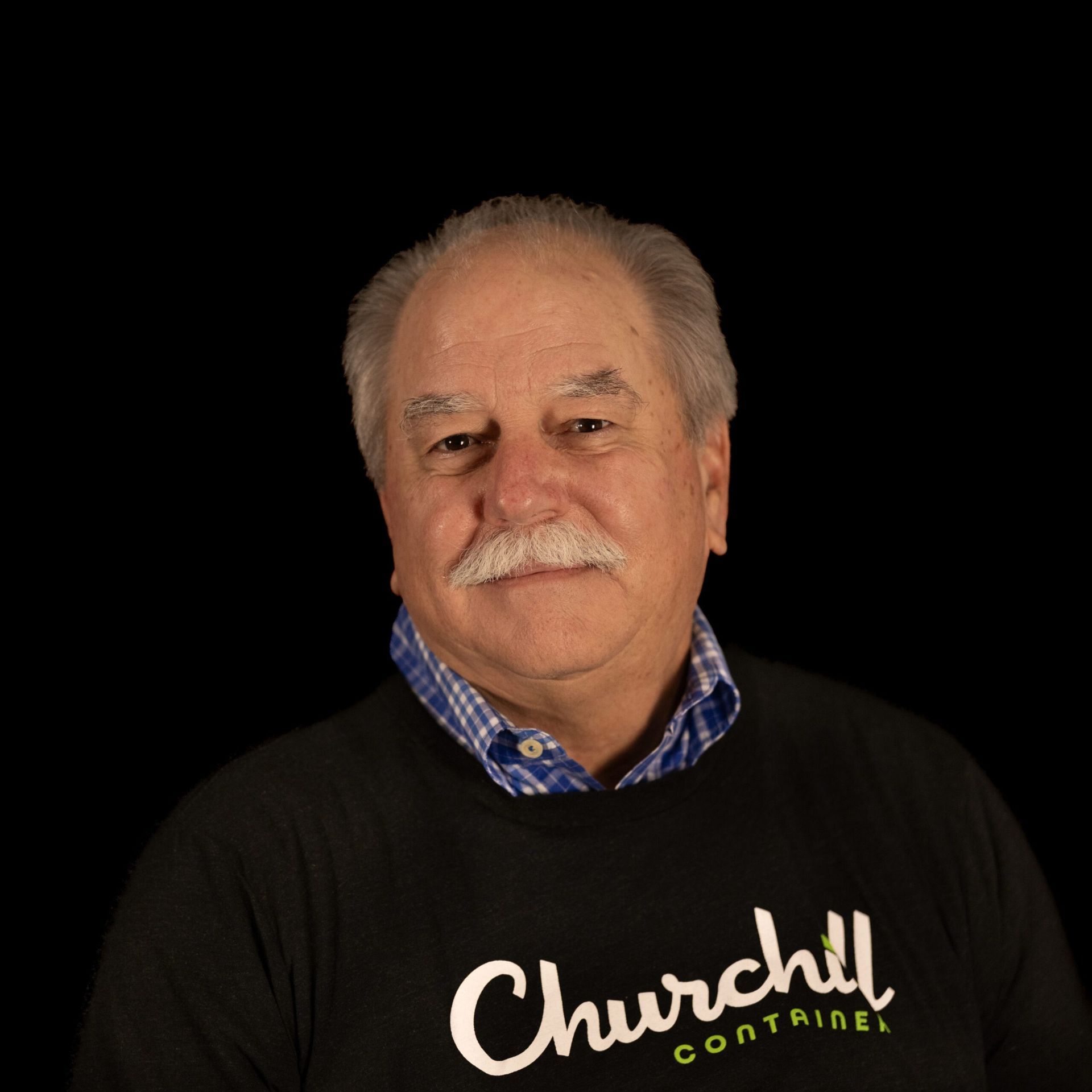 Man with a mustache wearing a black sweatshirt with 