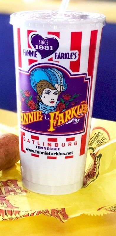 A large cup of Annie Farkle's drink in Gatlinburg, TN, with red and white stripes and a logo of a woman in a hat.