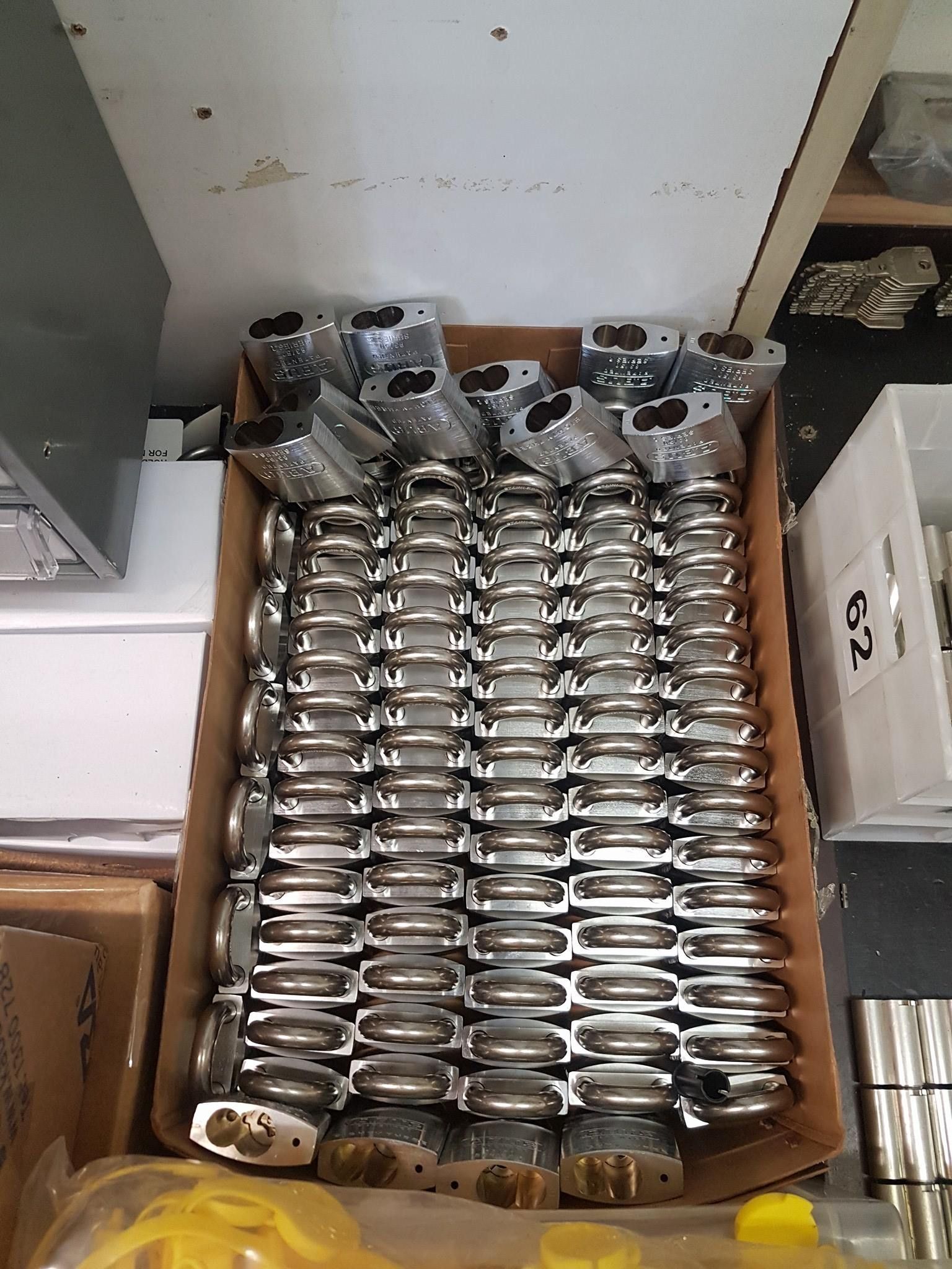 A cardboard box filled with rows of shiny silver locks - ADC Locksmiths in Wollongong, NSW