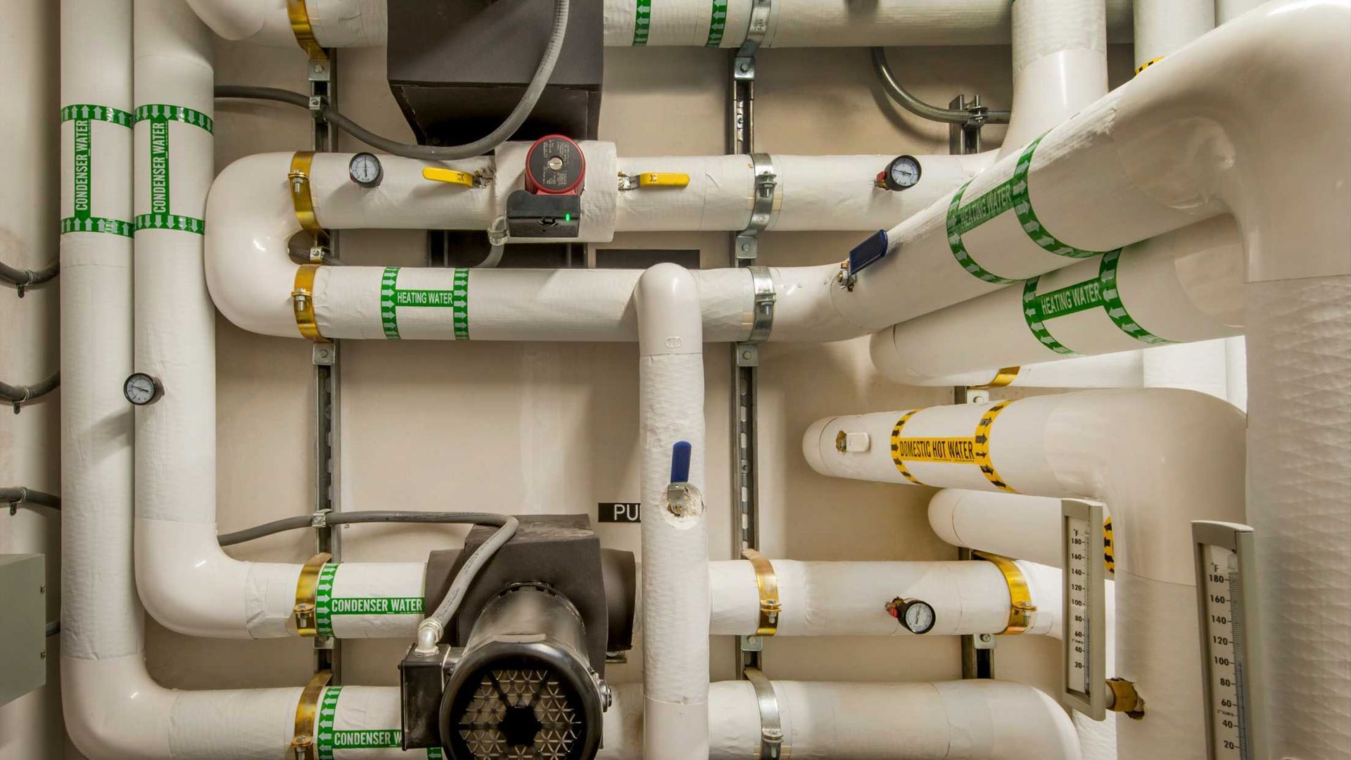 A bunch of white pipes are connected to each other in a room.