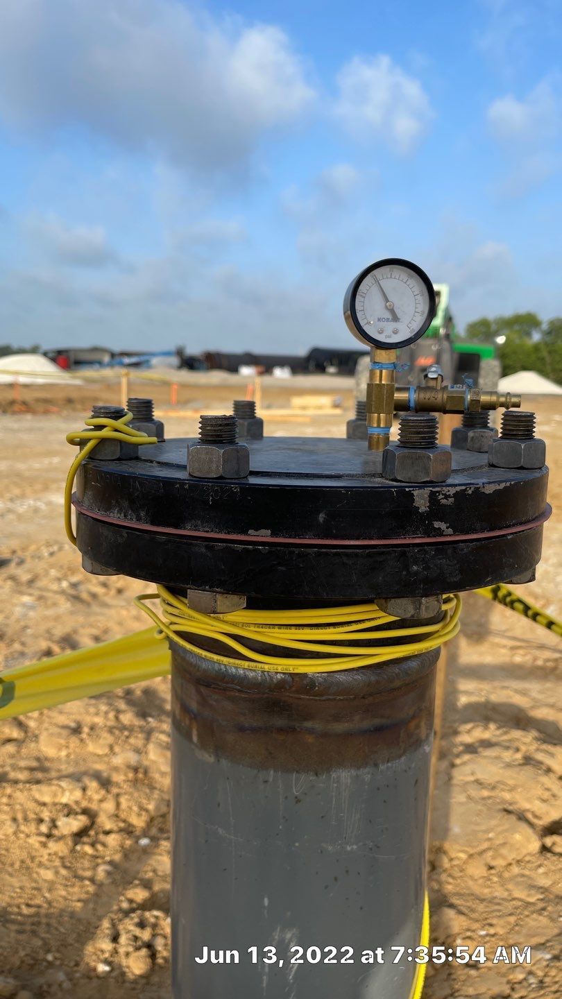 A close up of a pipe with a gauge on top of it.