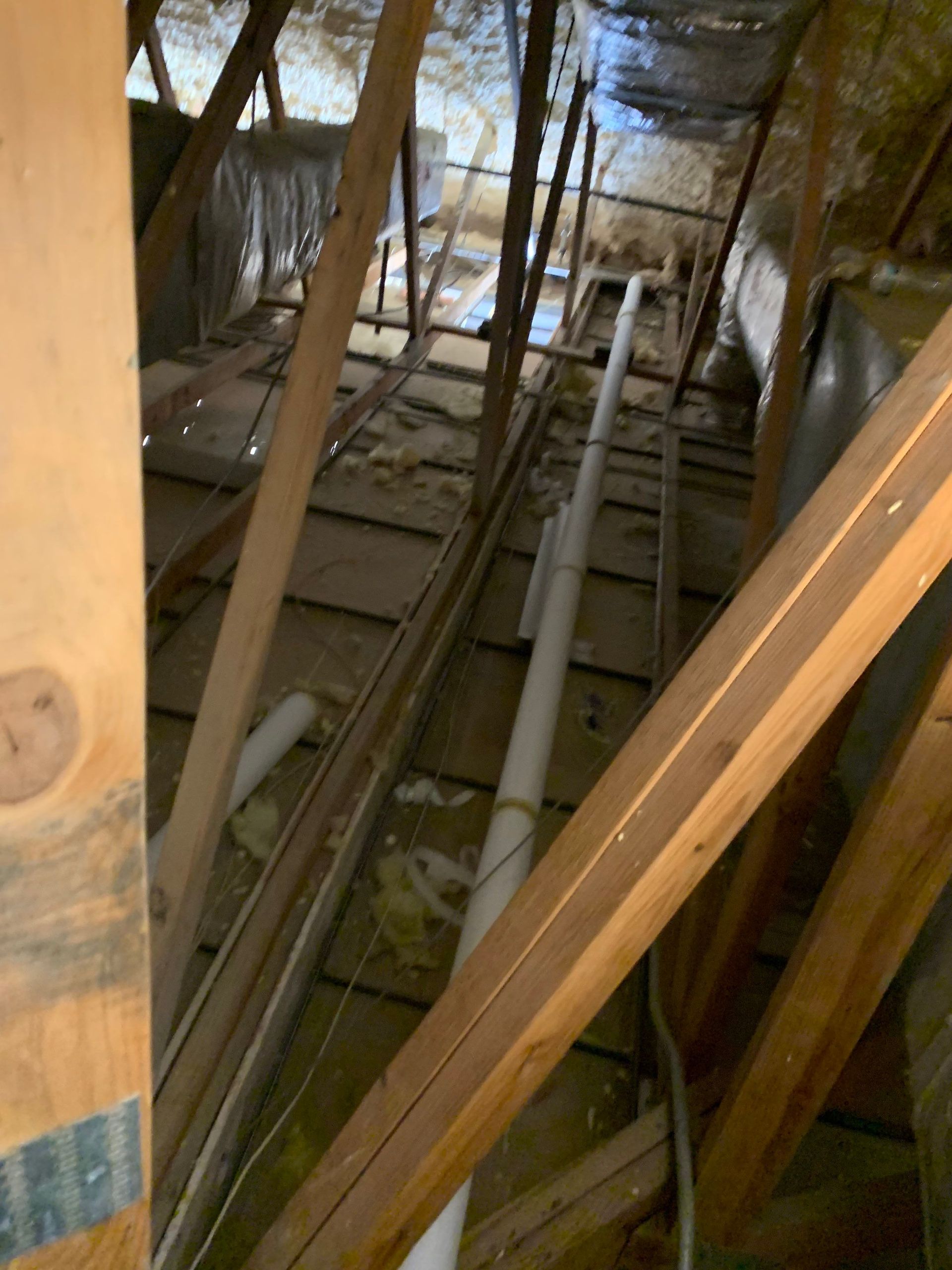 A room with a lot of wooden beams and pipes