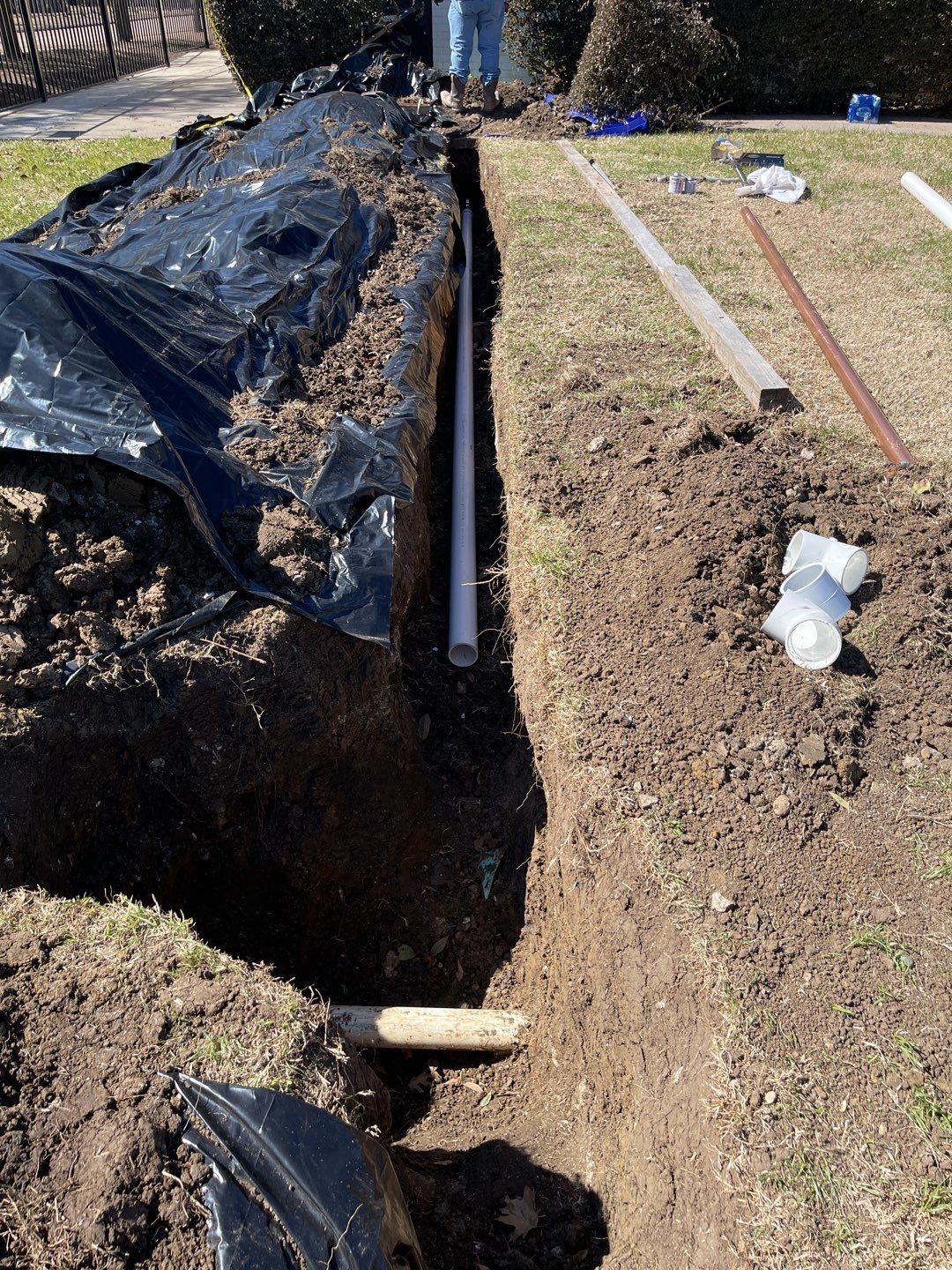 A pipe is being installed in a hole in the ground