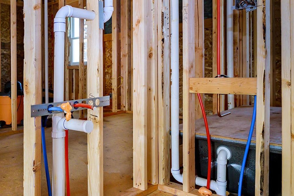 A house is being built with a lot of pipes in it.