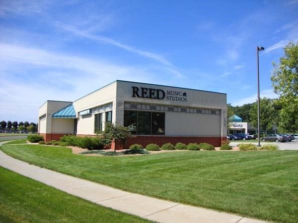 Reed Music Studio building with green lawn and blue sky.