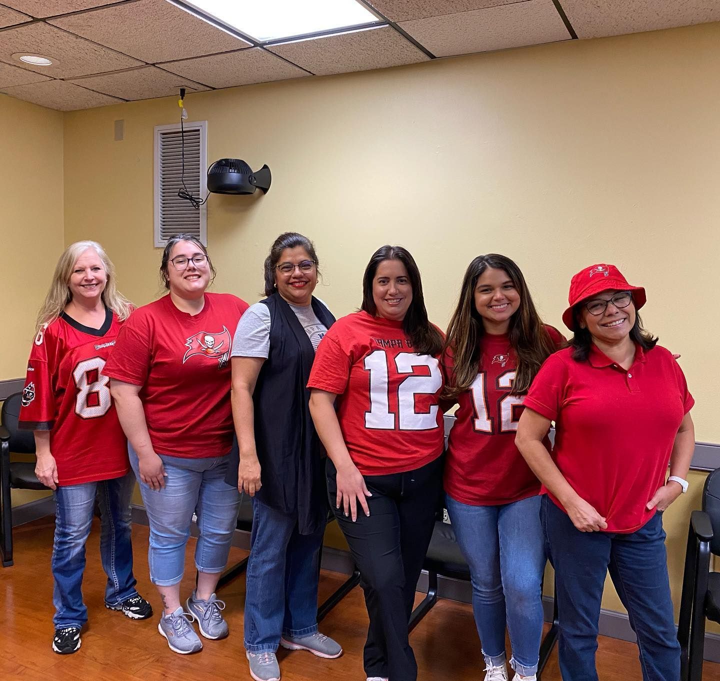 A group of women wearing red shirts with the number 12 on them